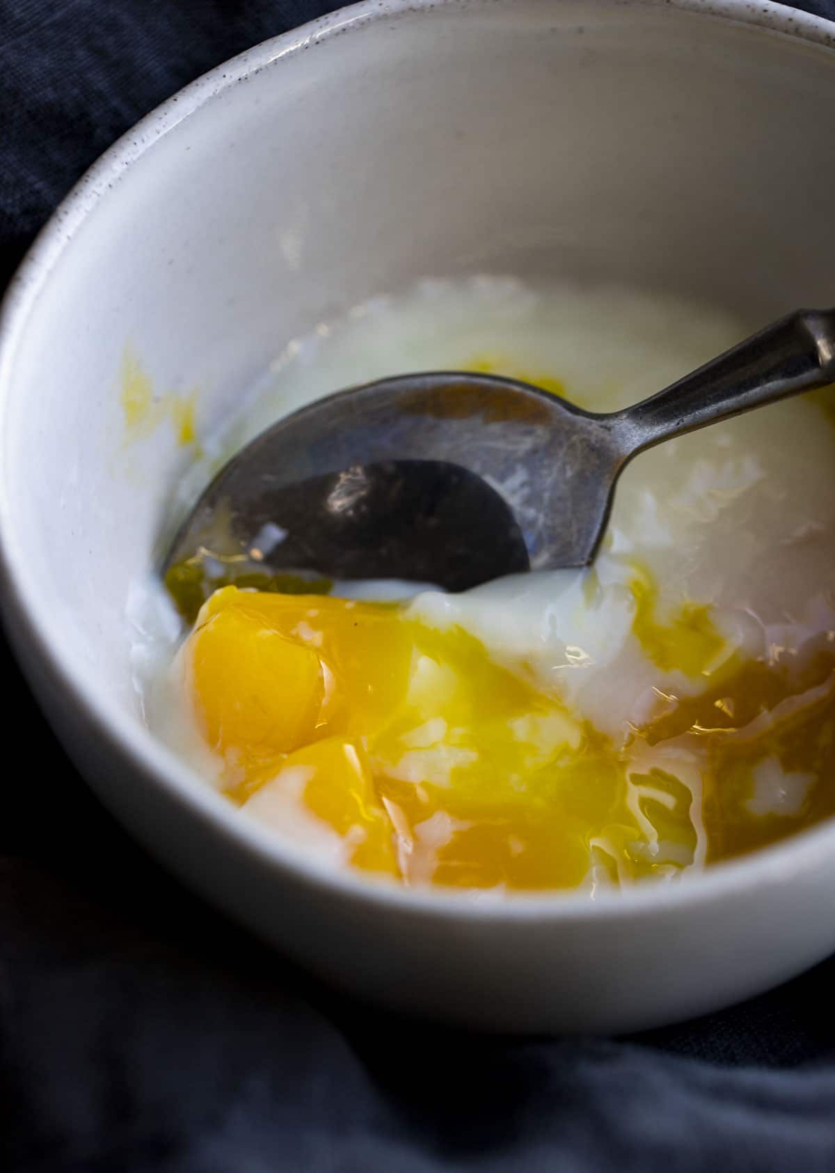 A bowl of poached egg, cut opened.