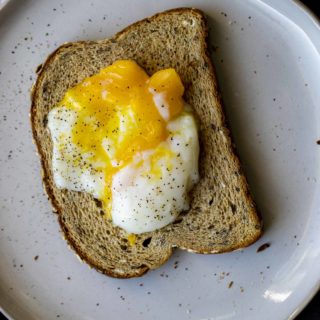 Poached egg over toasted bread.