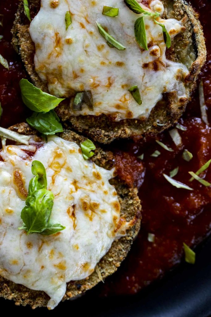 Close up of eggplant parmesan with melted mozzarella on top.