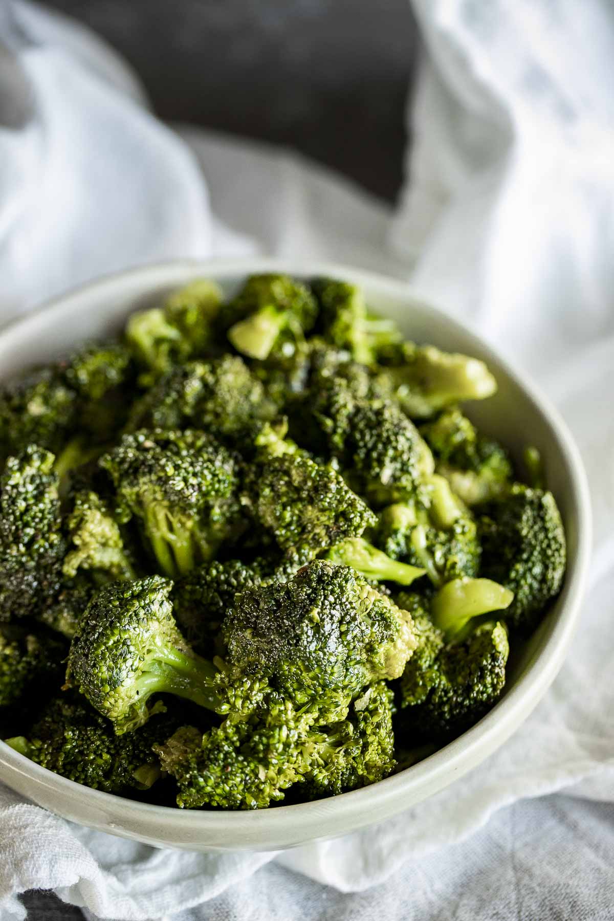 Sous vide broccoli in a white bowl.
