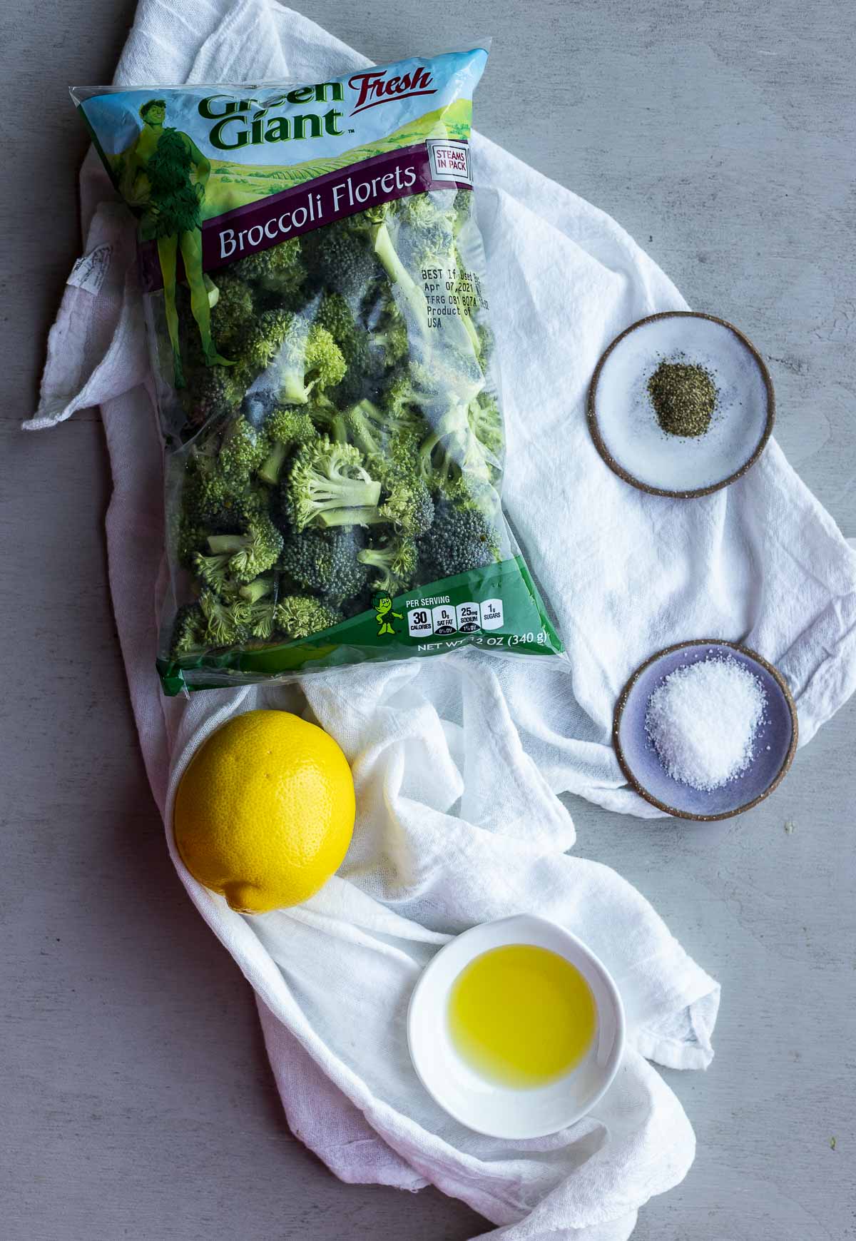Ingredients to make sous vide broccoli arranged individually.