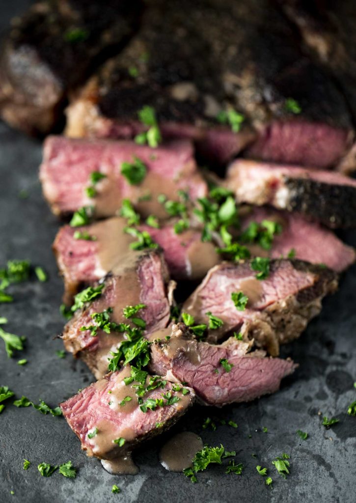 Up close view of sliced roast with gravy.