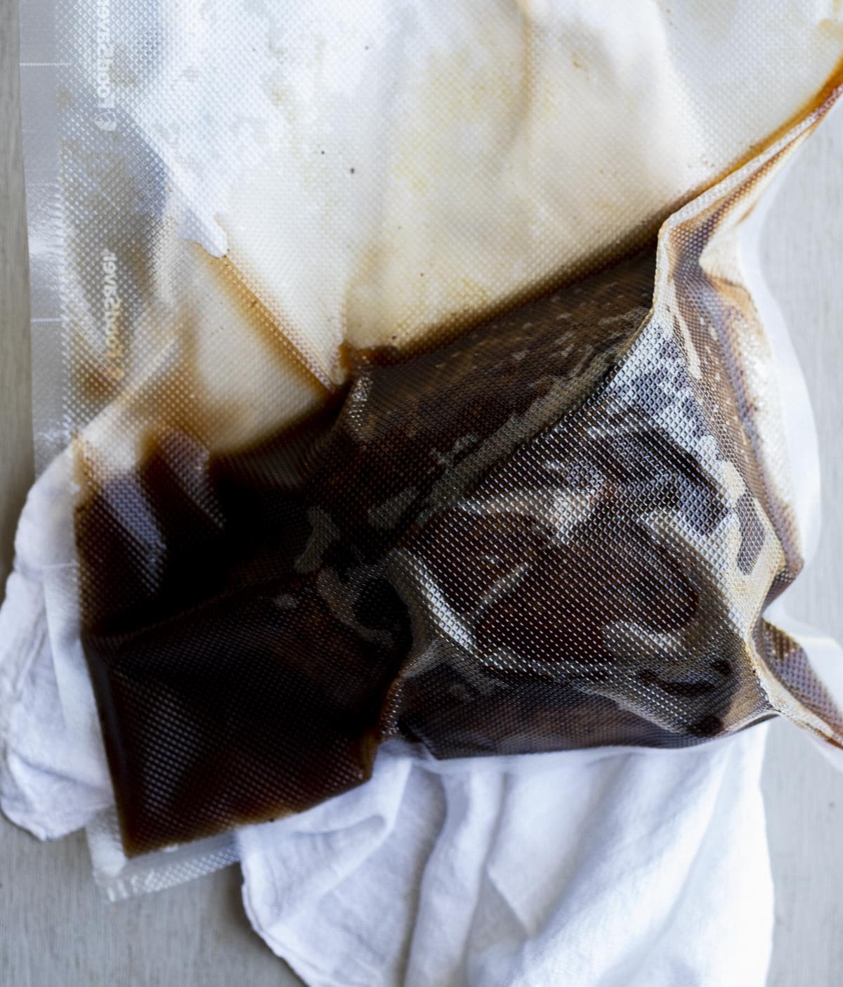 Sous vide round roast and jus in a vacuum sealed bag.