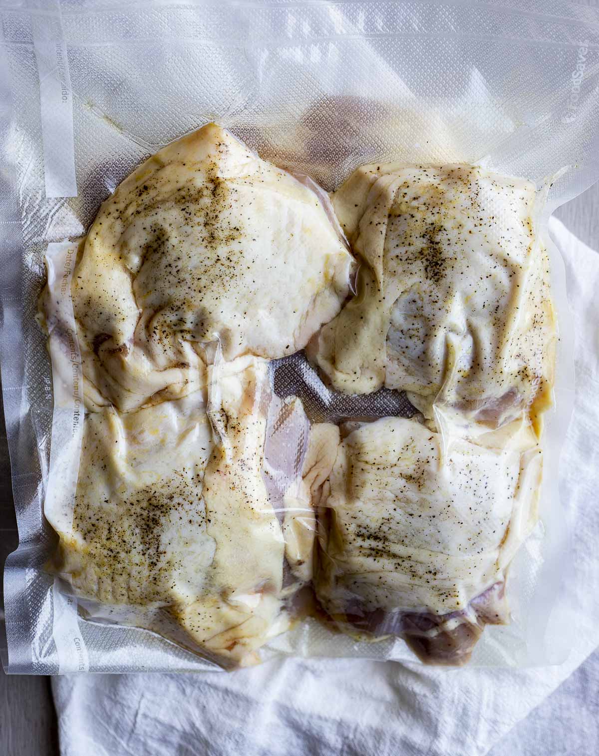 Chicken thighs vacuumed seal in a bag.