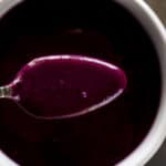 Overhead of a spoonful of blueberry curd.