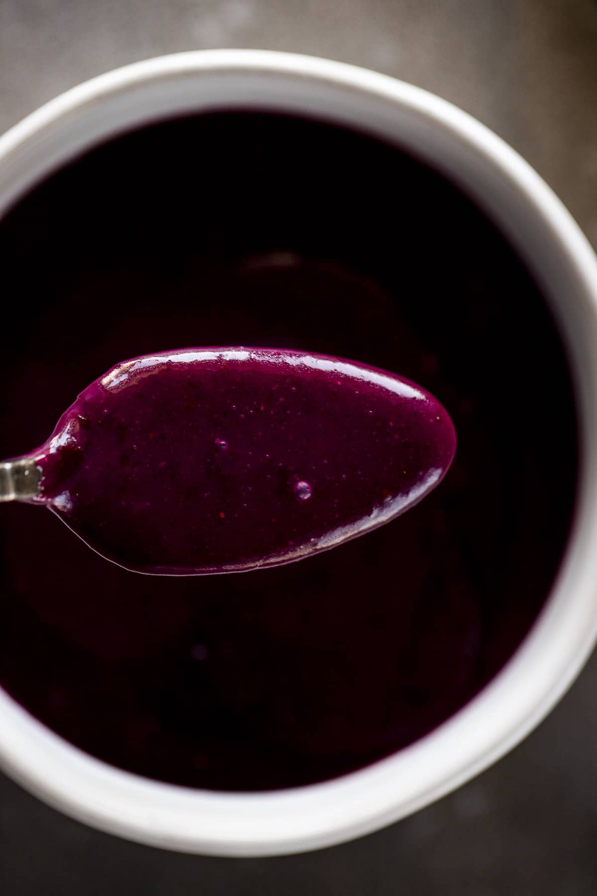 Overhead of a spoonful of blueberry curd.