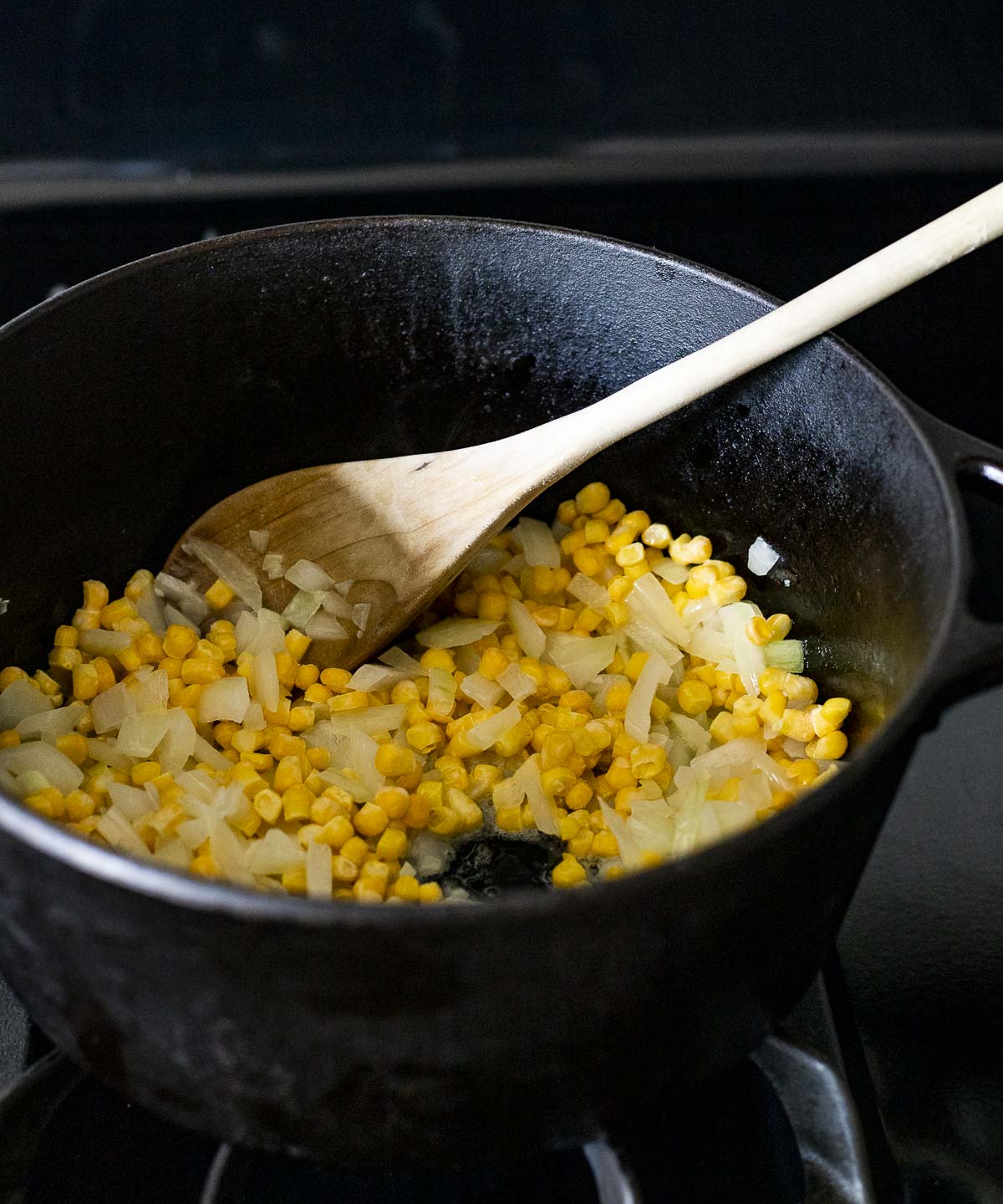 Corn, onion and garlic cooking in a Dutch oven.