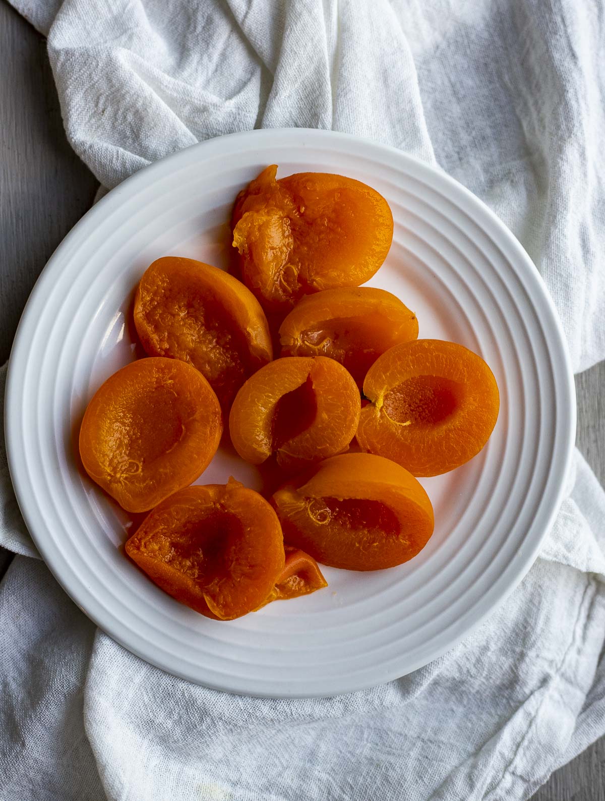 Apricot halves on a white plate.