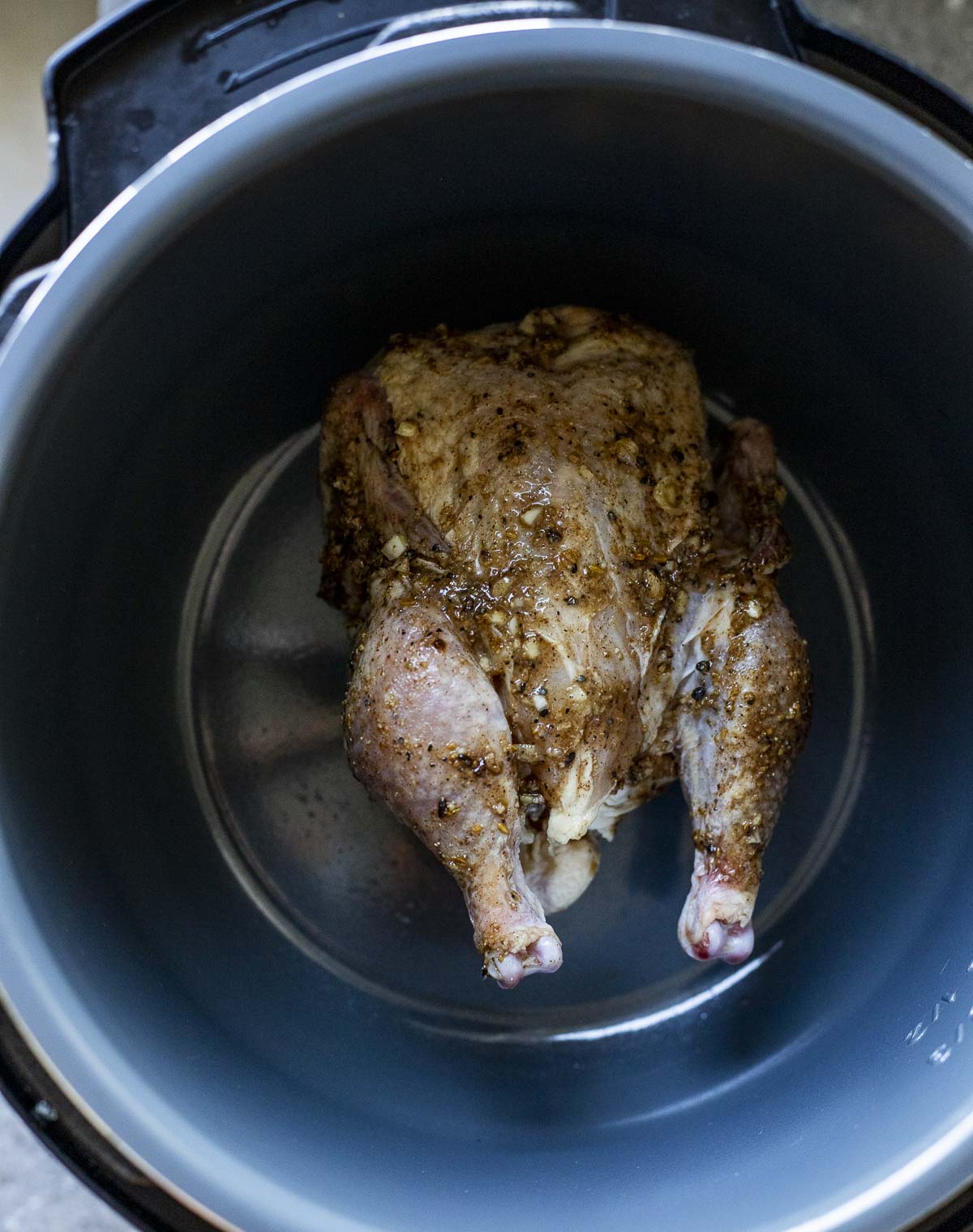 A Cornish hen being browned in the Instant Pot.
