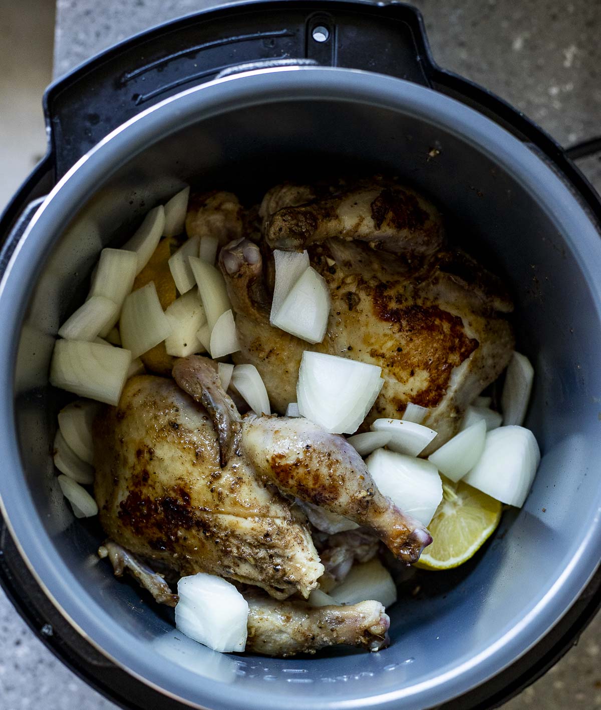 Cornish hens with the other ingredients in the Instant Pot.