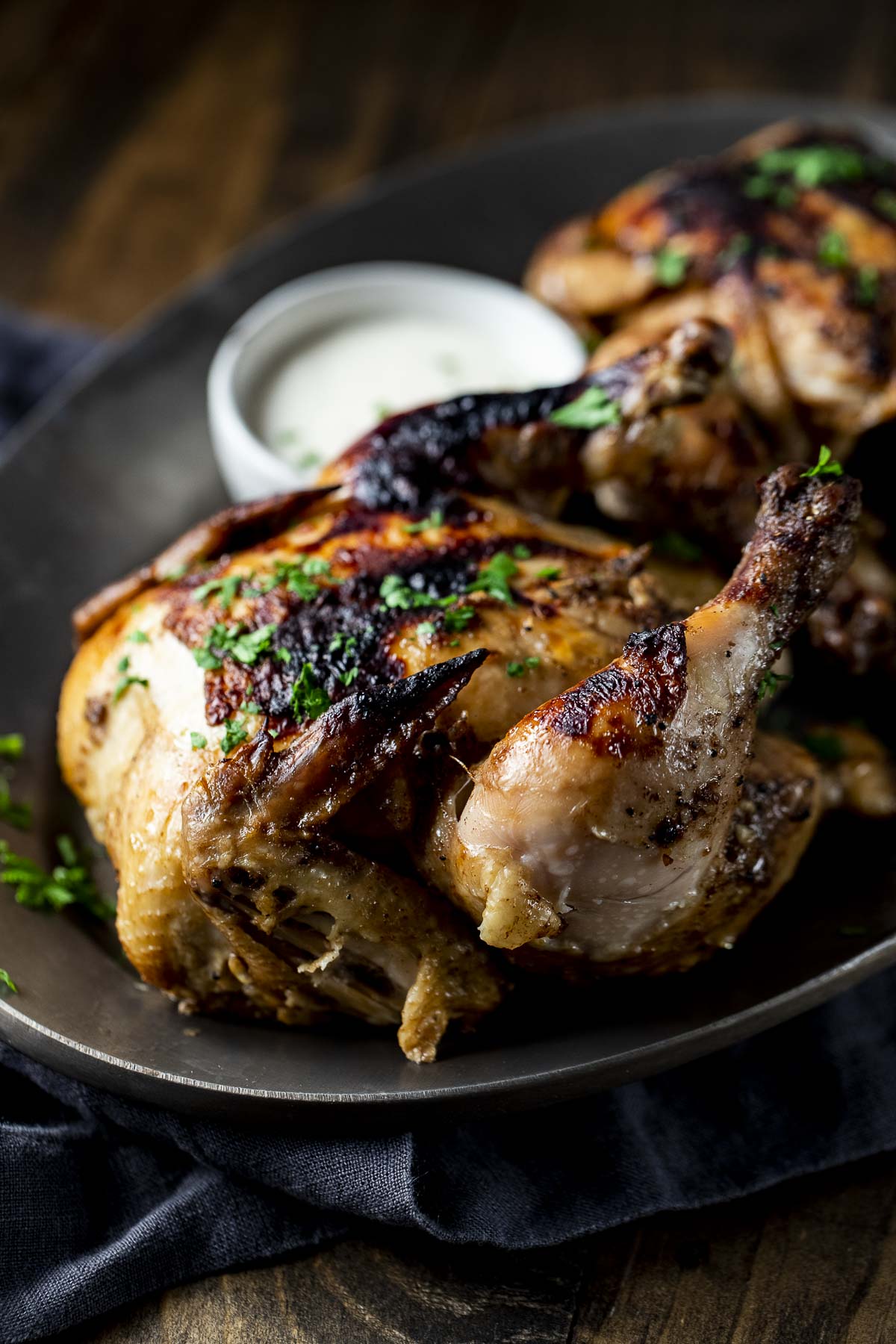 Side view of an Instant Pot Cornish hen on a platter.