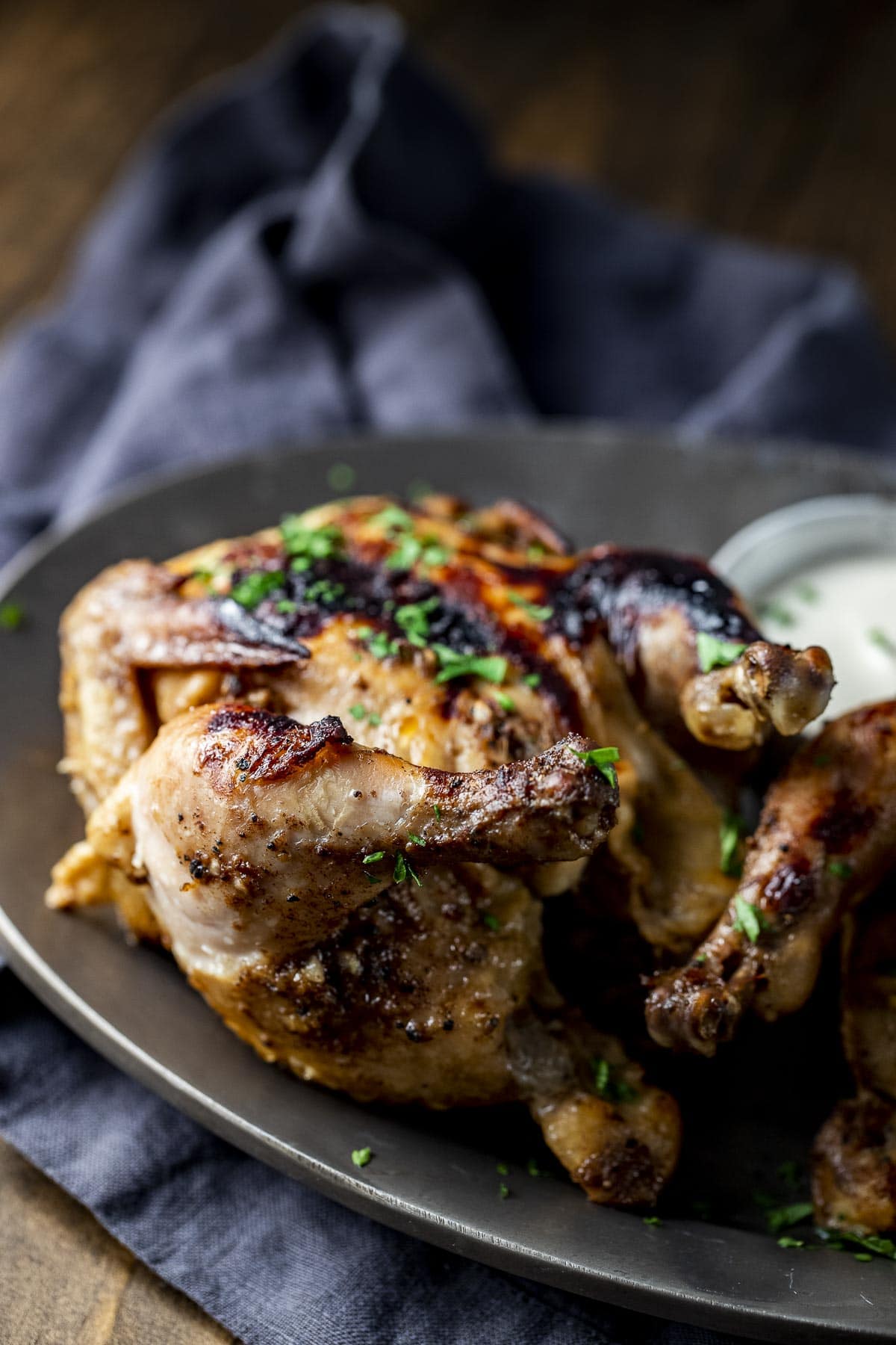 Side view of an Instant Pot Cornish hen on a platter.