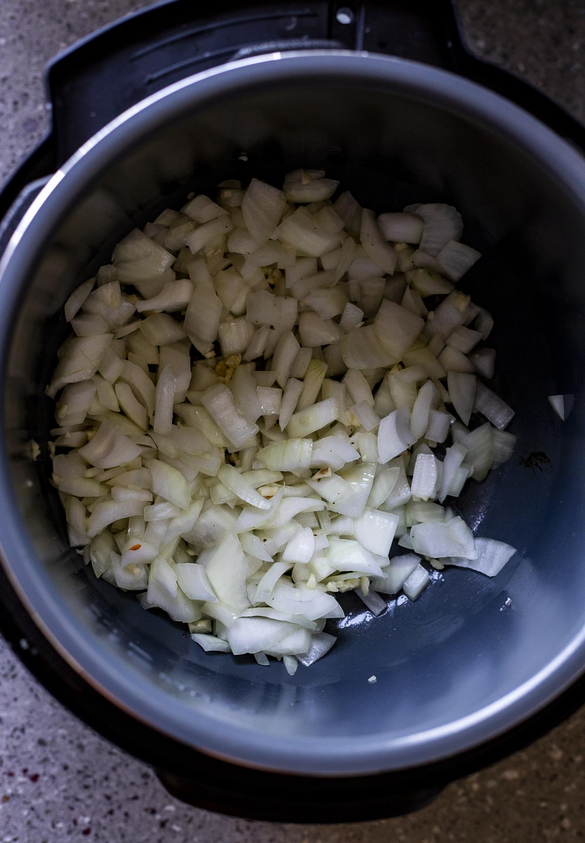 Chopped onions and garlic added to the Instant Pot.