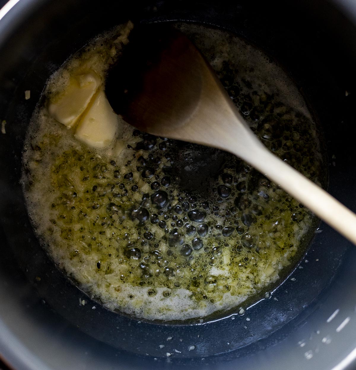 Garlic sautéing in butter and oil in the Instant Pot insert.