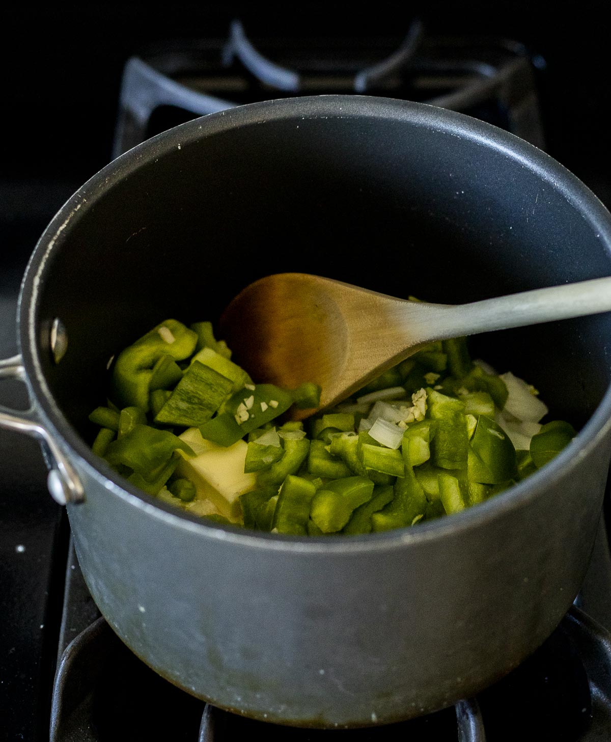 Green pepper, garlic and onion in a large pot.