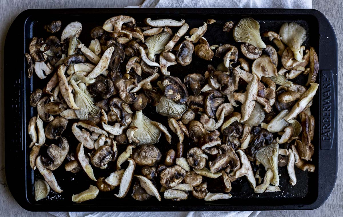Seasoned mushrooms on a sheet pan.