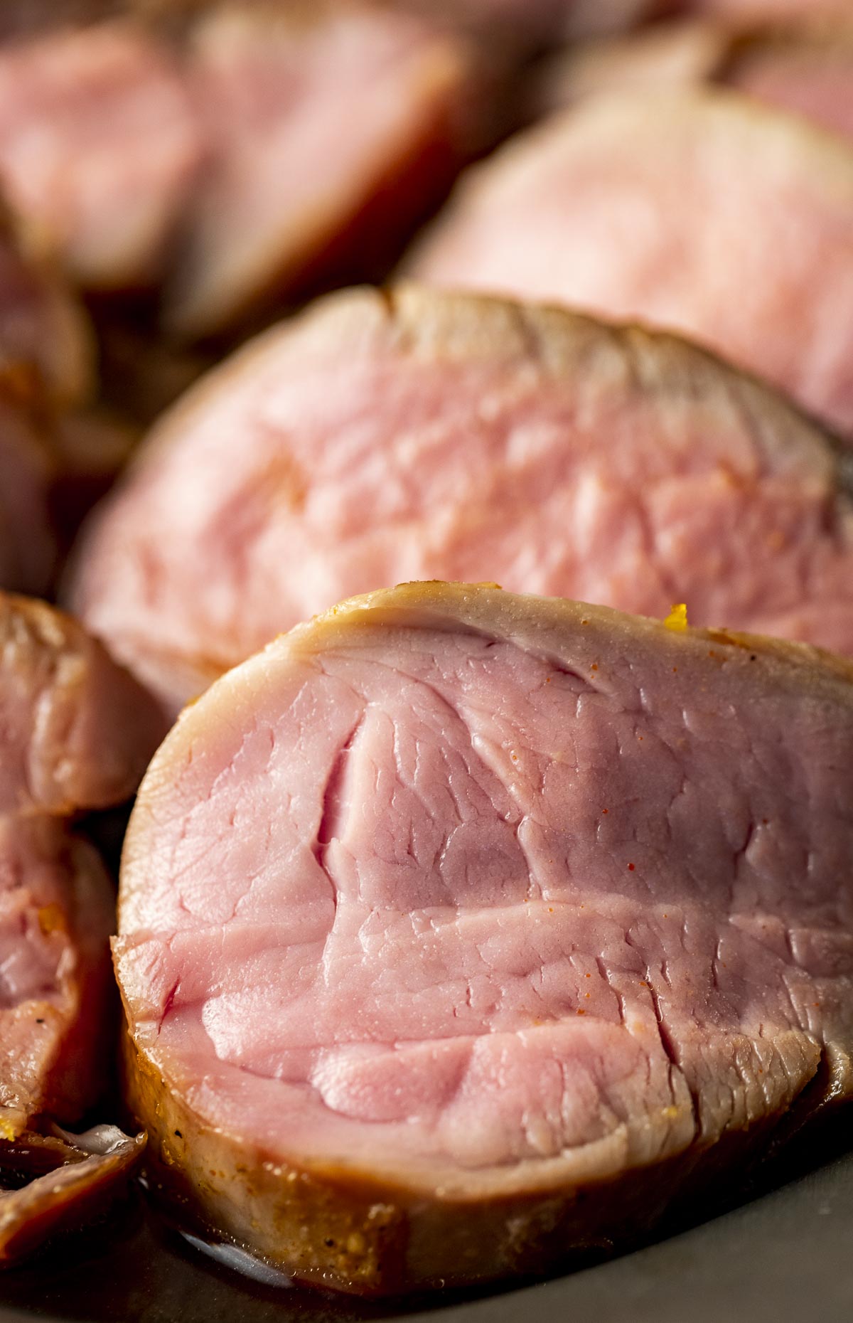 Close up of medium-rare pork tenderloin slices.