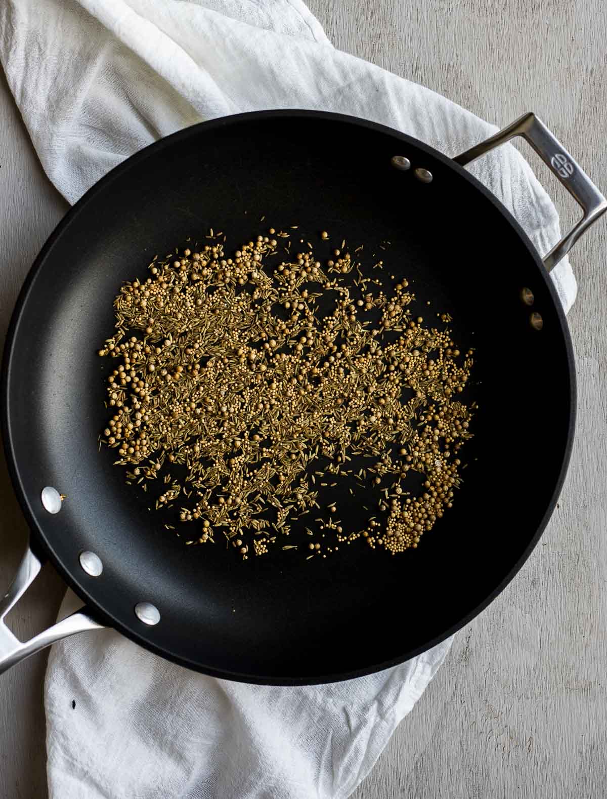 Toasted spices in a skillet.