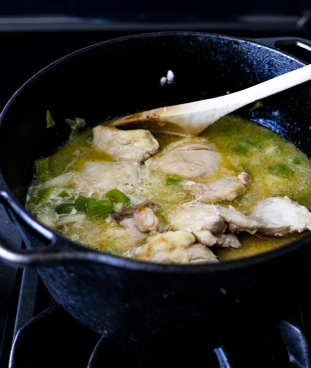 Chicken added into the pot with the broth.