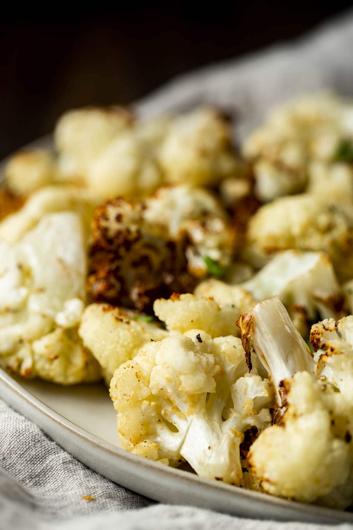 Side view of air fryer cauliflower on a plate.