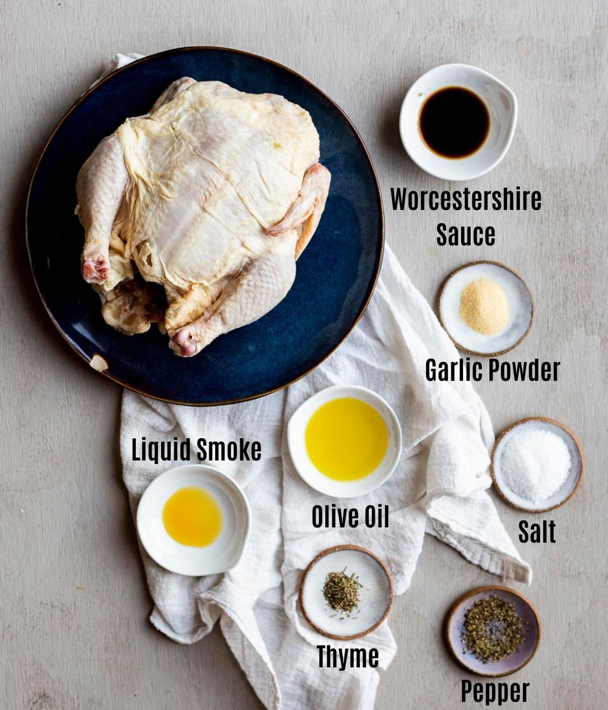 Ingredients to make air fryer whole chicken arranged individually and labelled.