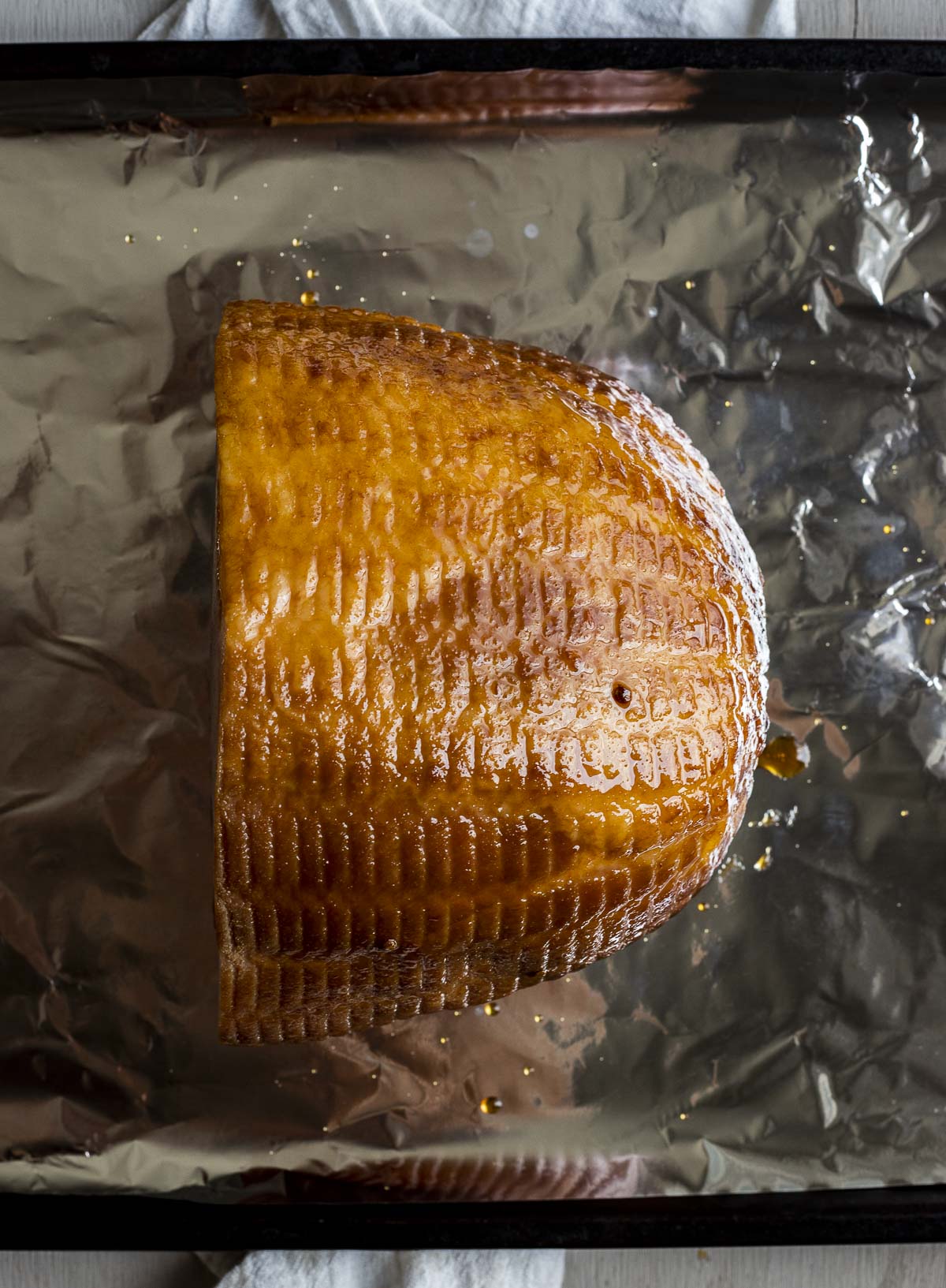 Overhead view of sous vide ham on a sheet of tinfoil.