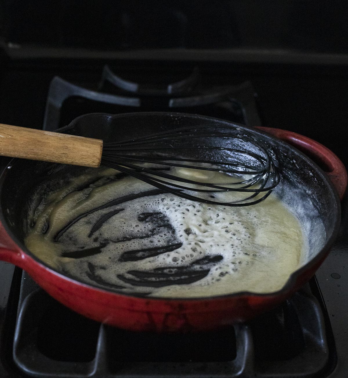 Flour and butter whisking together to make a roux.