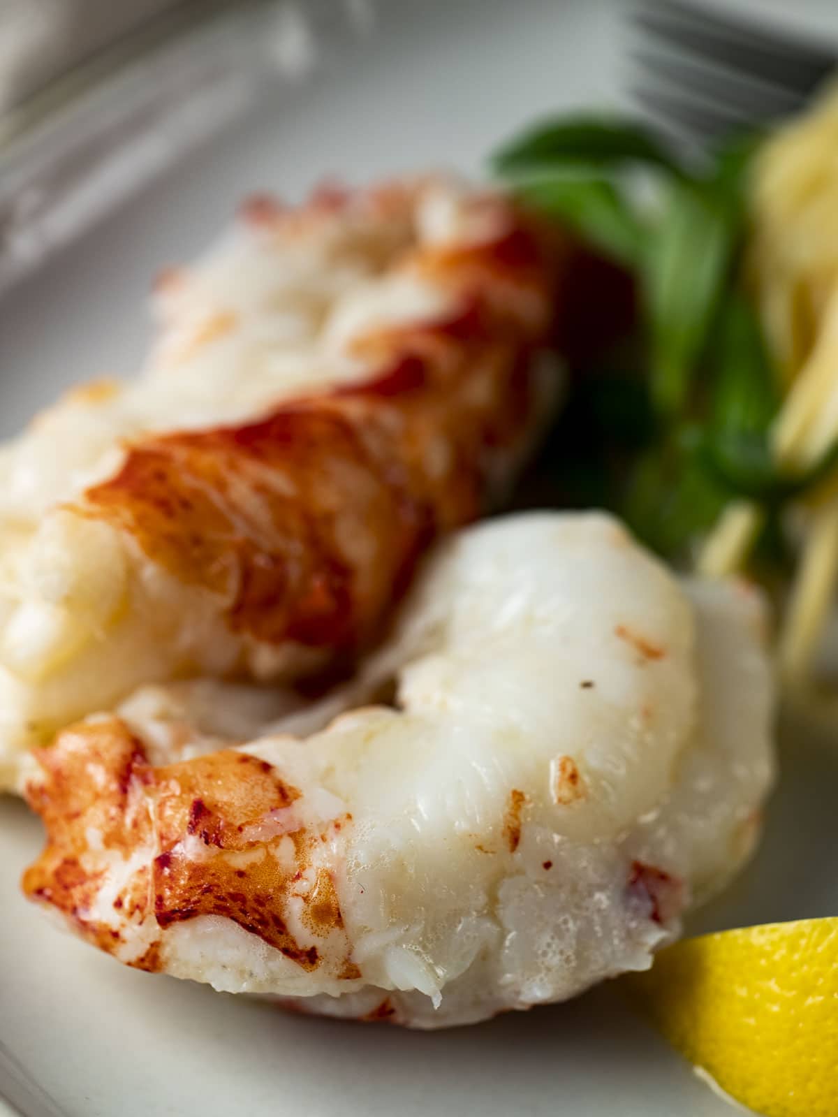 Close up of sous vide lobster tails on a plate.