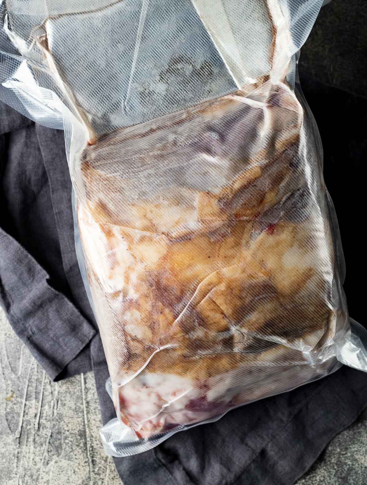 Rib roast sealed in a large sealable bag.
