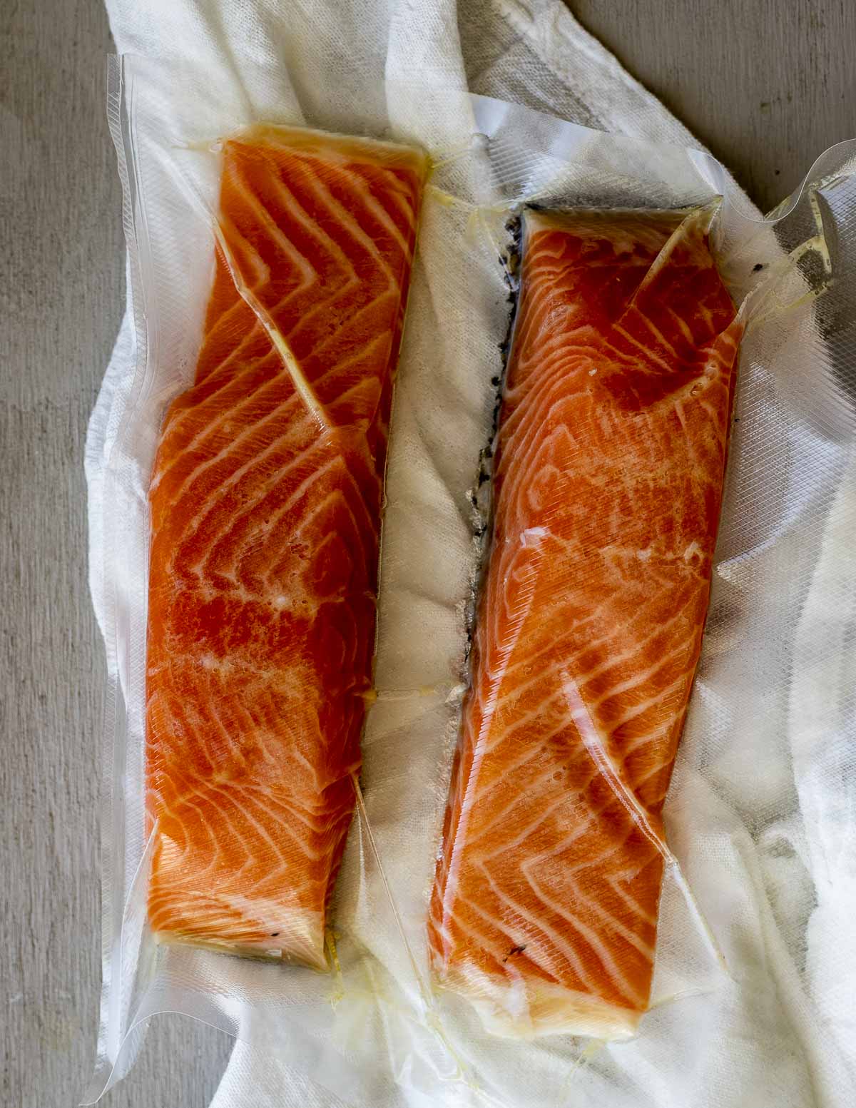 Two salmon portions sealed in a sealable bag.