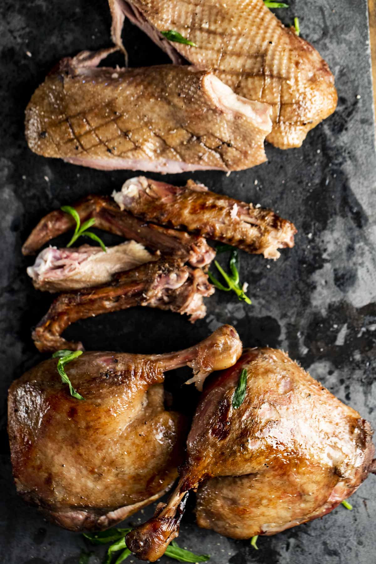 Overhead view of a carved whole duck on a pan.