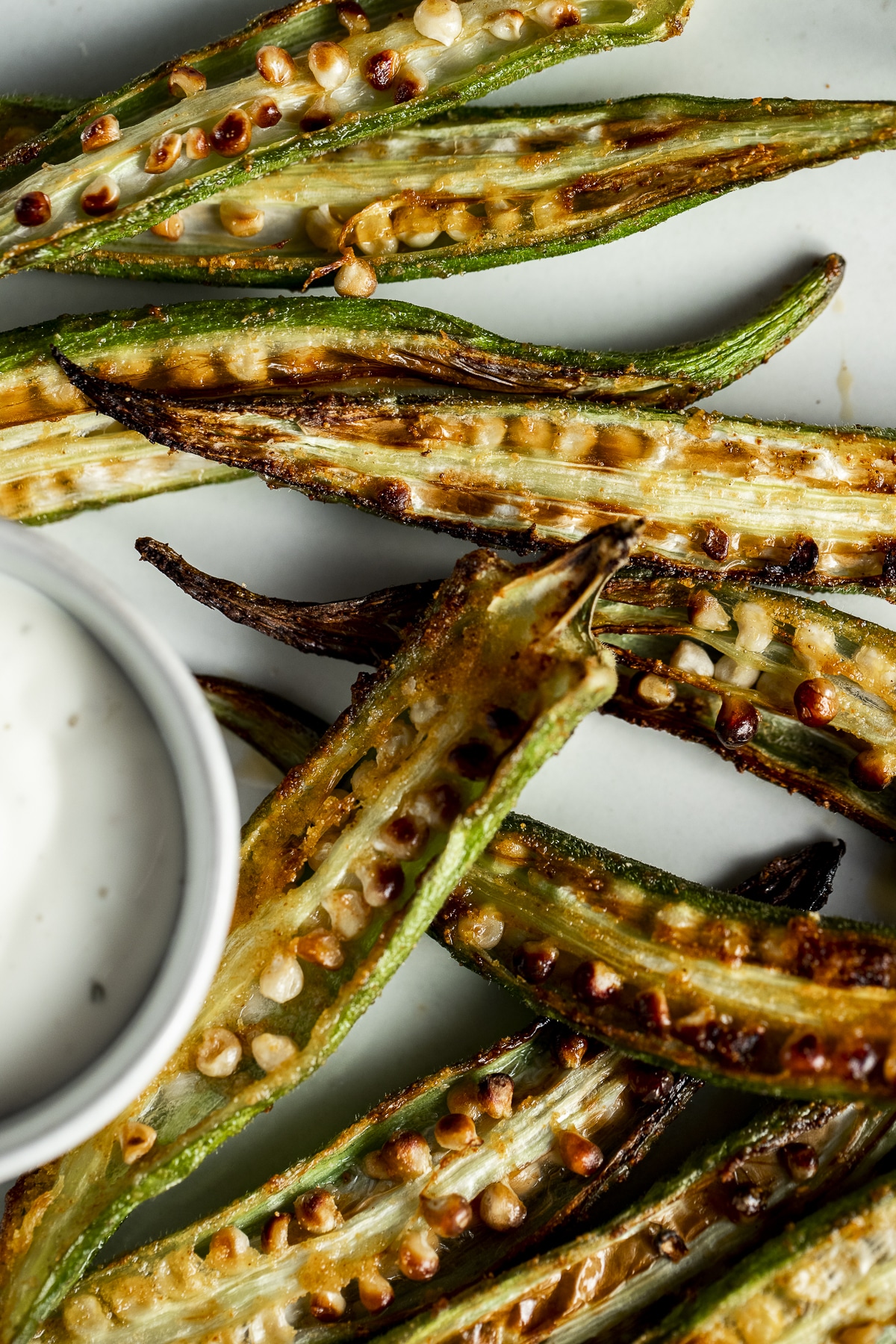 Close up of air fryer okra on a white plate.