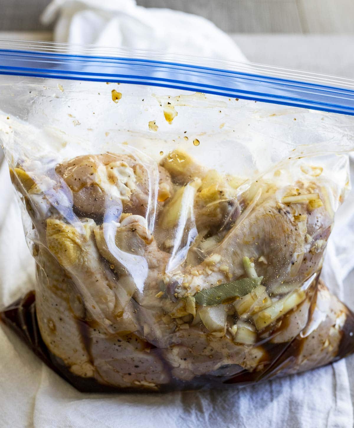 Marinated chicken drumsticks in a ziplock bag.