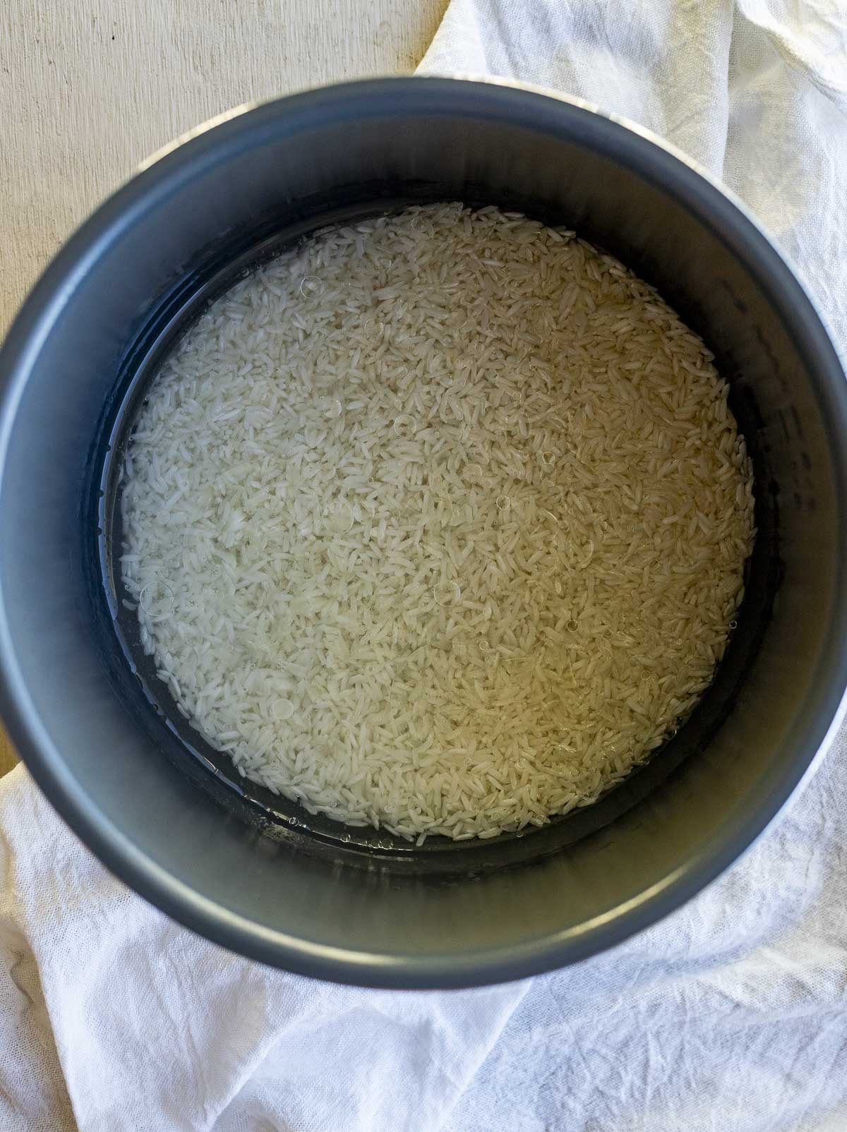 Jasmine rice in water in the Instant Pot insert.