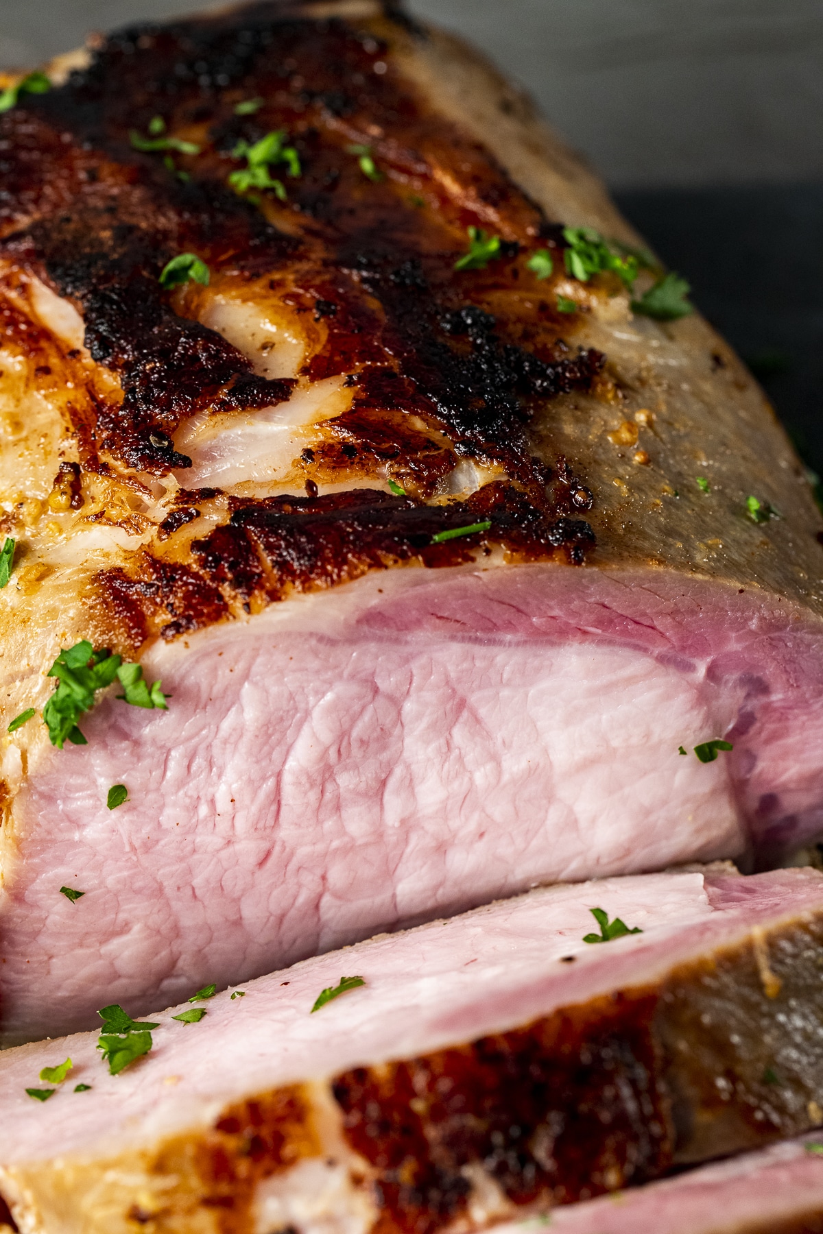 Close up view of a sliced pork loin roast.