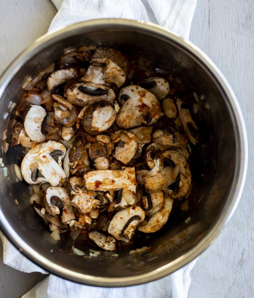 onions and mushrooms cooking in a pot