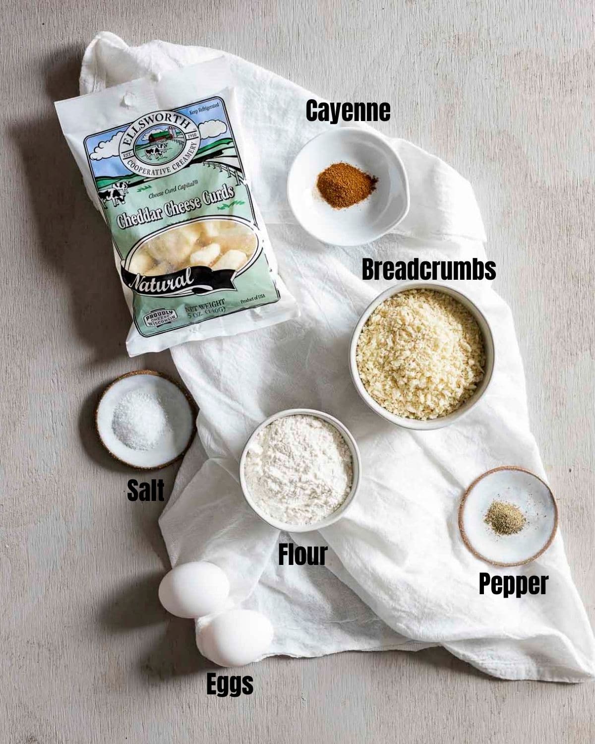 Ingredients to make air fryer cheese curds arranged individually and labelled.