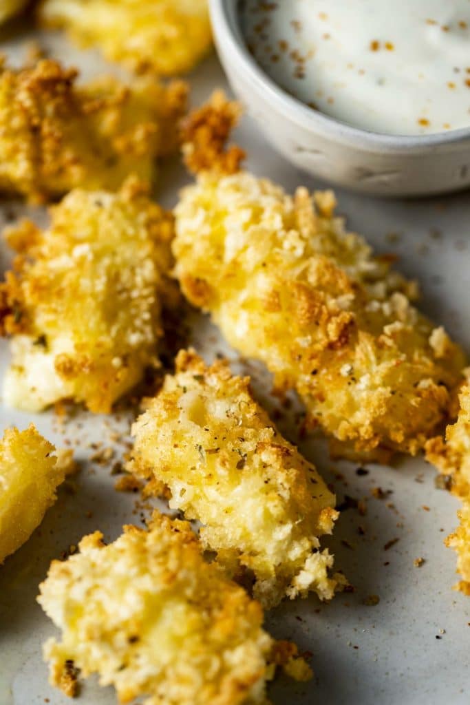 Close up view of breaded cheese curds on a plate.