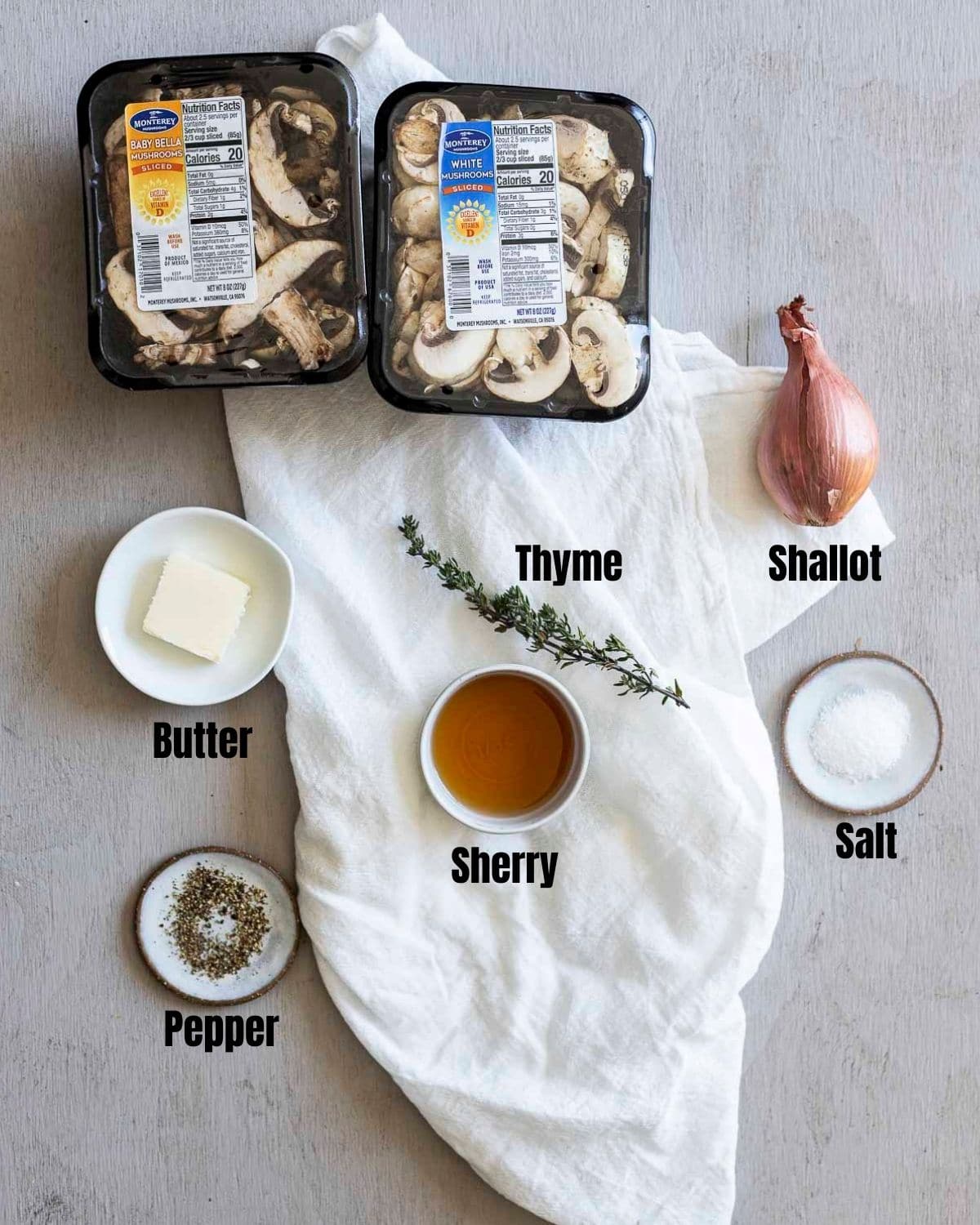 Ingredients to make sherry mushroom sauce arranged individually and labelled.