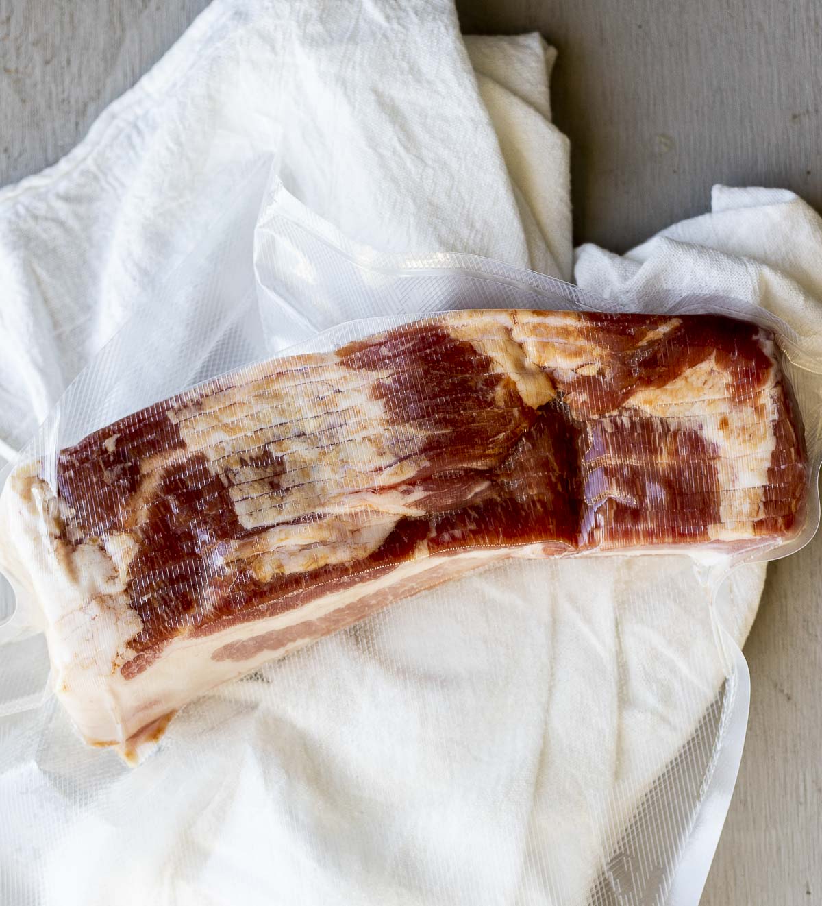 Thick cut bacon vacuum sealed in a bag.
