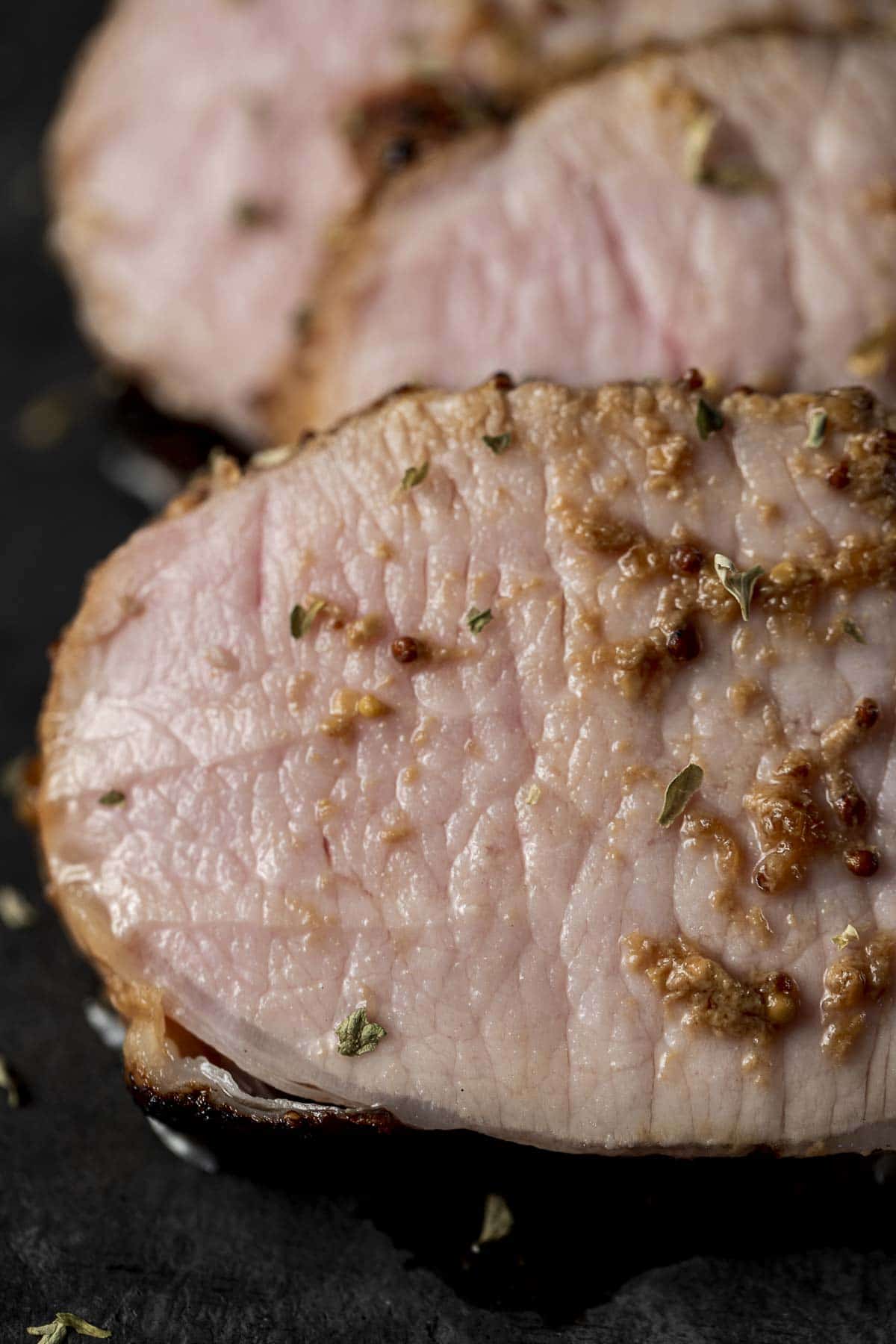 Close up view of a slice of juicy pork roast.