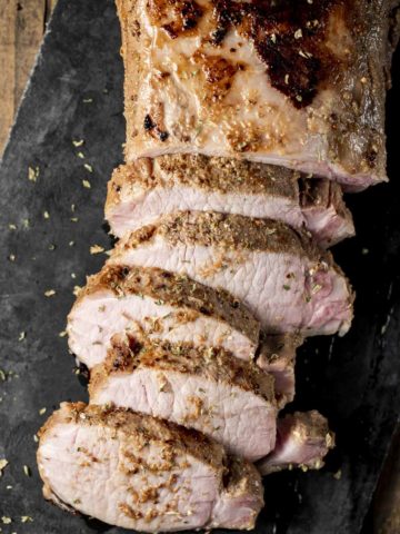 Overhead view of a pork roast cut into slices.