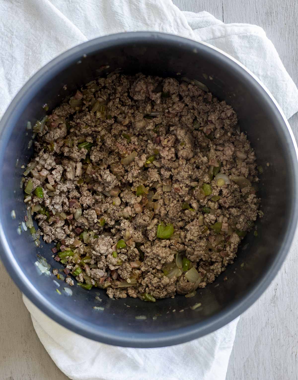 Ground meat browned with the veggie mixture in the Instant Pot insert.