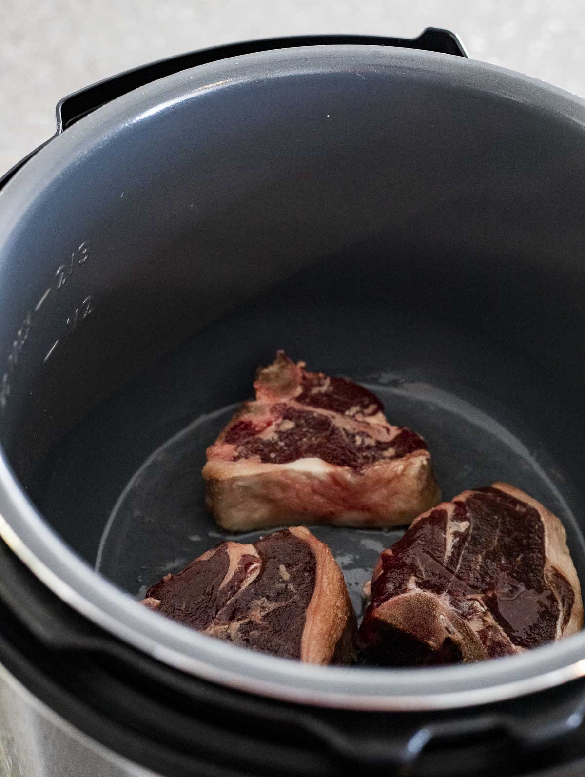 Lambs chops browning in the Instant Pot insert.