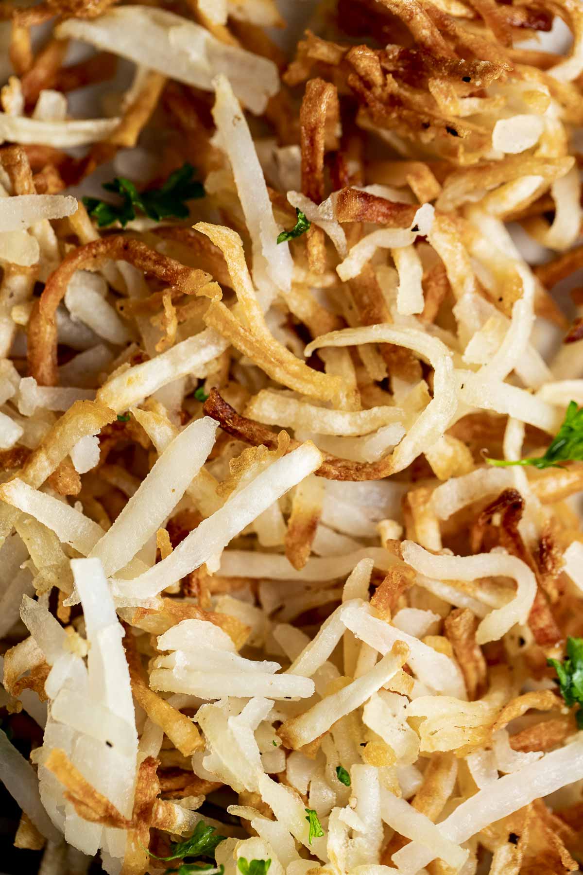Close up view of air fried shredded hash browns.