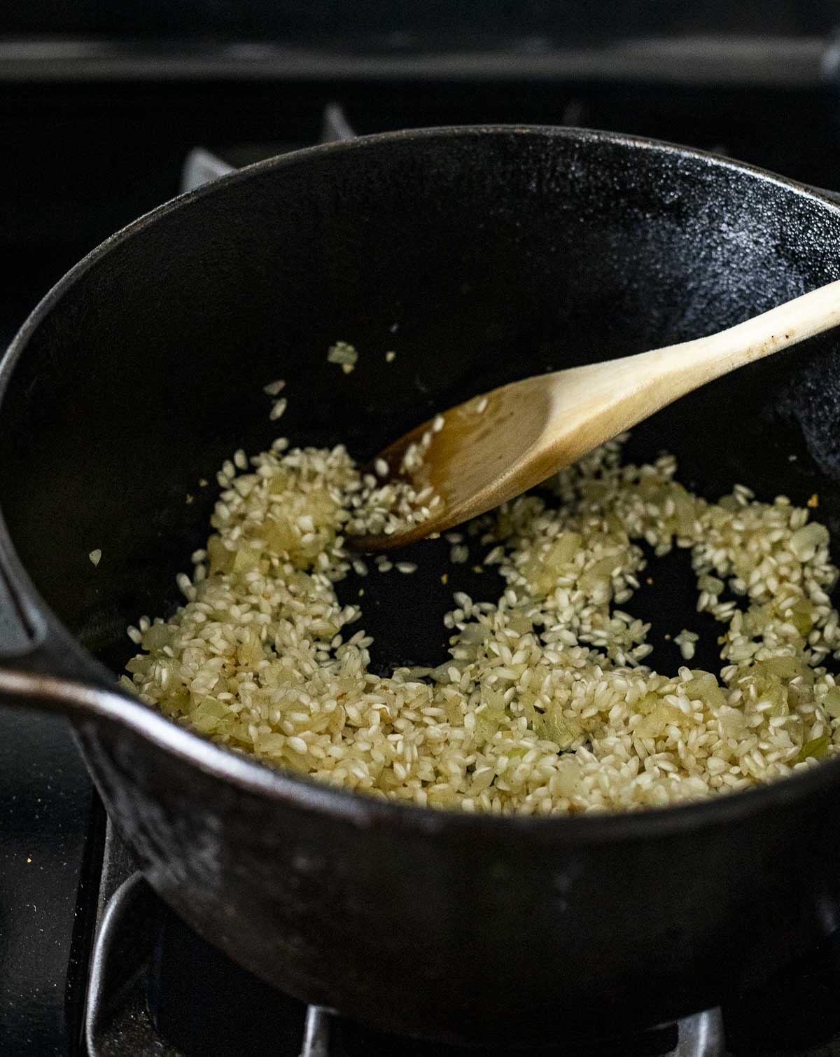Rice being toasted with the garlic and onions in a Dutch oven.