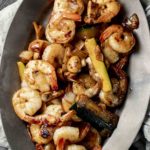 Overhead view of shrimp hibachi served on an oval platter.