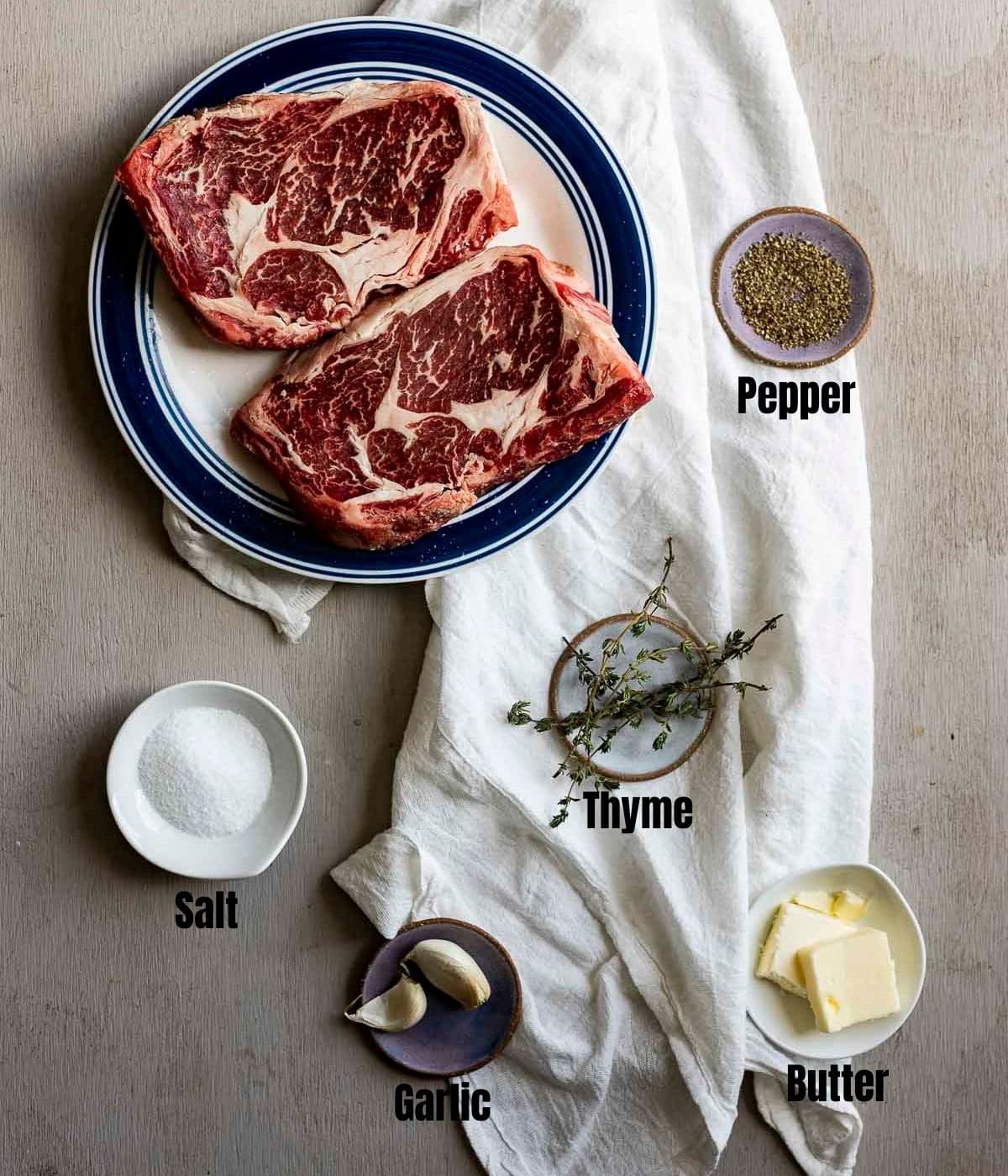 Ingredients to make sous vide ribeye arranged individually and labelled.