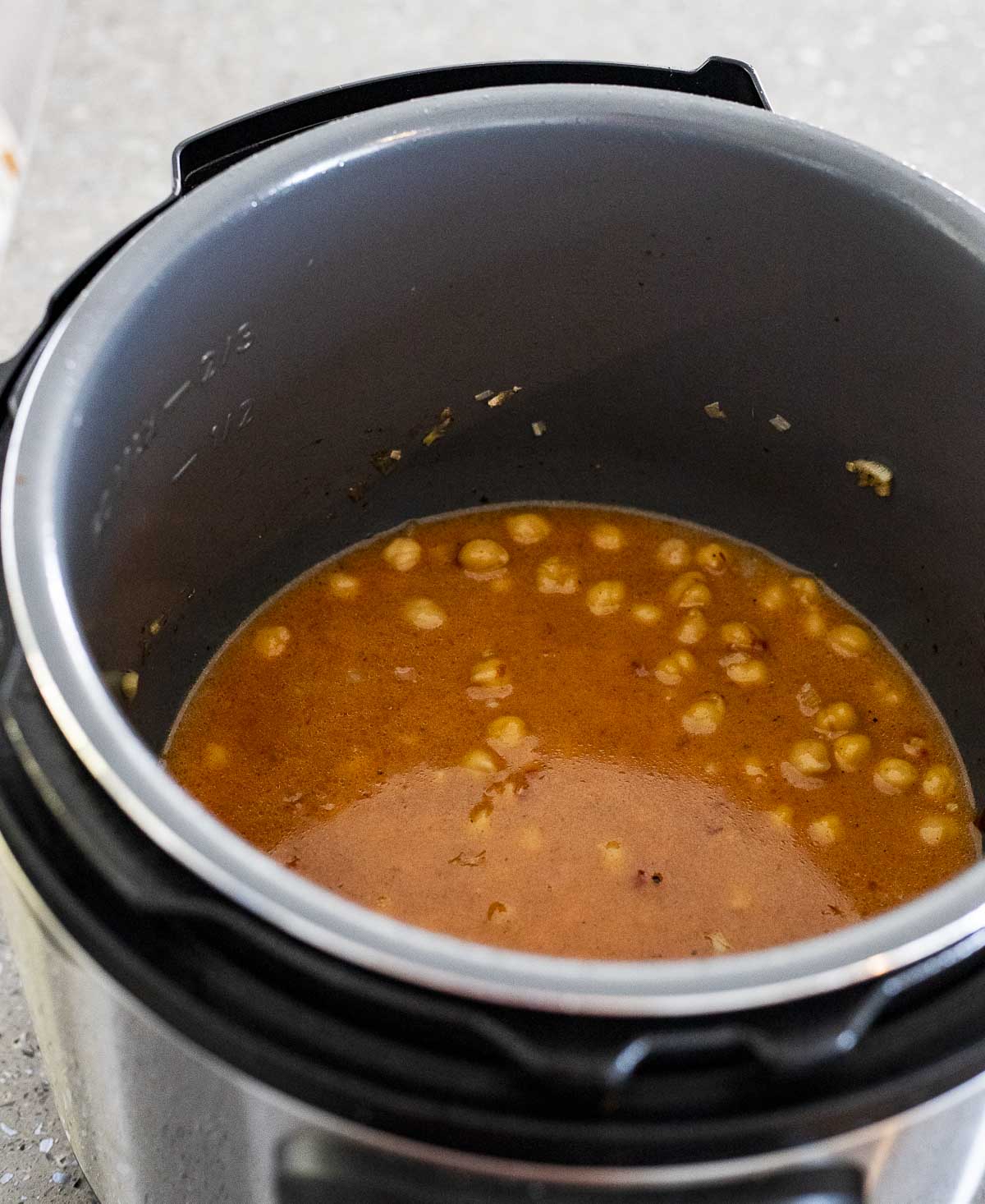 Broth, coconut milk, chickpeas and other ingredients in the Instant Pot.