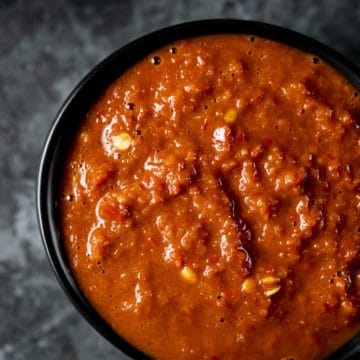 Overhead view of sambal belacan in a black bowl.